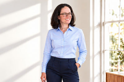 A woman in the Tuckerman pale blue poplin shirt, styled photo